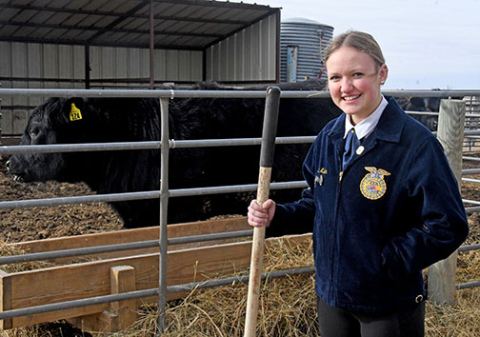 Hampton FFA president Macy Miller stands next to the Hawk Herd corral behind the school. Miller is a booster for beef, agriculture and FFA and plans to attend Northwest Missouri State University this fall to major in ag education, following in the footsteps of both of her parents. 