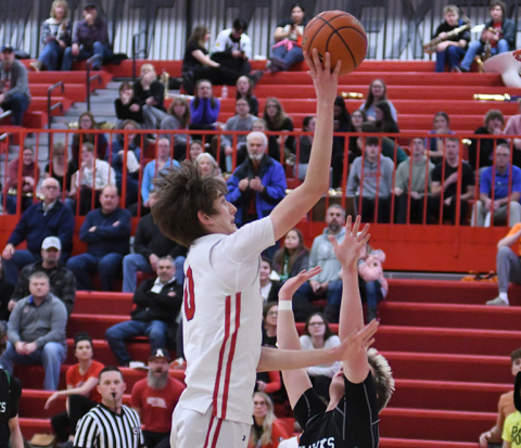 Aurora freshman Jaxson Slagle goes up strong for two of his team-high 16 points in Thursday’s dramatic 49-48 win over Omaha Skutt. Slagle hit the game-winning shot as time expired.
