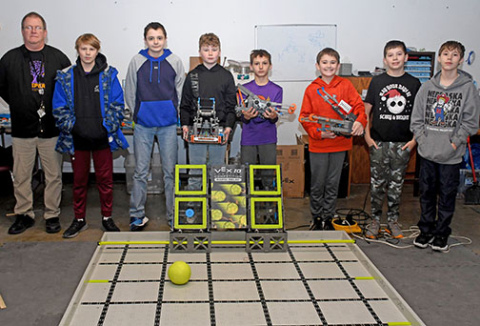 Members of the Hampton Elementary and Middle School robotics team pose for a picture with the robots they built by this year’s competition game. From left are team sponsor Gary Richards, Daniel White (7th grade), Ethan Litz (7th grade), Lawson Haberer (7th grade), Uriah Brooks (4th Grade), Deven Dose (6th Grade), Reis Stump (6th Grade) and Christopher Brooks (6th Grade). Not Pictured: Isaiah Venteicher (4th Grade), Camron Vandermate (7th Grade), Olivia Lemburg (7th Grade) and Samuel Venteicher (7th Grade).