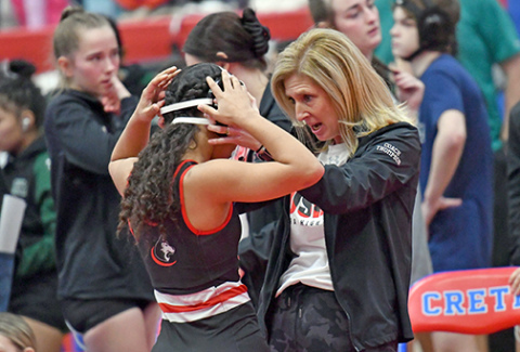 Aurora coach Sheri Thompson shares a few motivational words with Aubrie Beed ahead of her opening match at Saturday’s Central Conference tournament in Crete. Beed finished with a third. 
