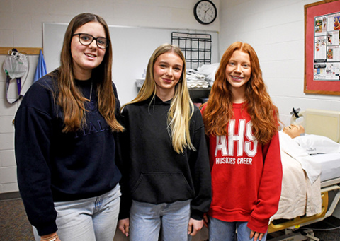 Aurora High School provides a CNA program to train students to become certified nurses aides after completing the certification. Students who are currently taking the course include, from left, Emary Rhoades, Faith Utley and Ellie Brown.