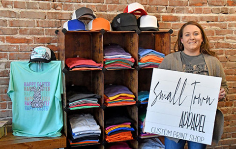 Christine (Holliday) Bruner is the owner and designer of Small Town Apparel in downtown Aurora. Bruner offers custom prints as well as local school, business and Nebraska wear at her new location at 1123 13th St.