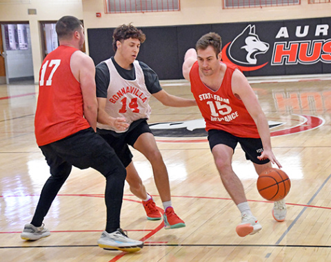 Class of 2007-11’s Caleb Shivley rolls past the screen of Ben Peard set on 2024’s Tyson Dvorak during the first half of 07-11’s 43-40 win in Saturday’s championship final. It was the first tournament victory for anyone from those five classes. 
