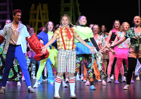 Eva Yllescas as SpongeBob SquarePants sings with the cast of Aurora High School's production of "The SpongeBob Musical."