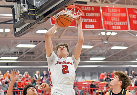 Booker Scheierman throws down one of his two first-quarter dunks that brought the home crowd to life. However, Gretna East survived the early onslaught from Aurora and came back to defeat the Huskies 50-40 in Monday’s B-8 district final. 