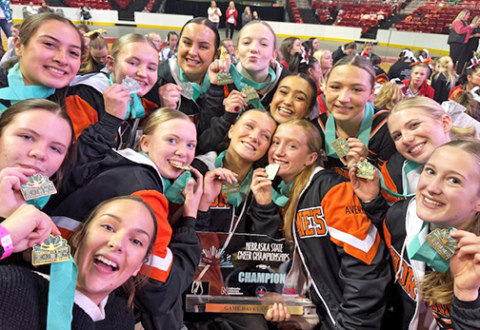 The Hampton High School cheerleaders pose for a victory photo after winning their school's first state cheer championship trophy. 
