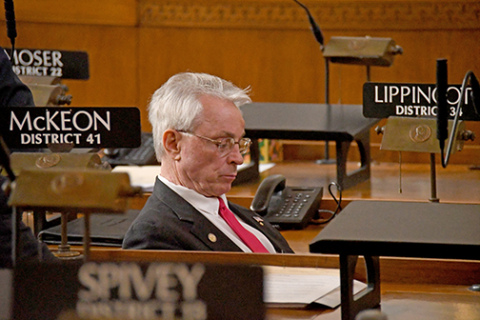 Sen. Loren Lippincott sits in his desk on the floor of the Nebraska Senate.