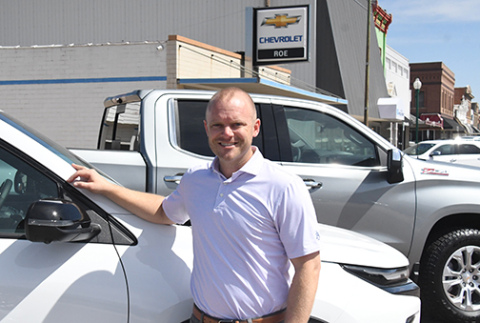 Jason Roe stands in front of the Roe Chevrolet dealership in downtown Aurora, where plans have been announced to expand the service department.