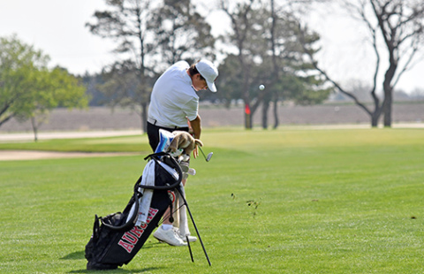 Aurora freshman Cash Garrett hits his approach shot into the par-4 fifth hole where he ended up with par. Garrett eagled his final hole to shoot 75 and finish ninth overall for his first varsity medal. 