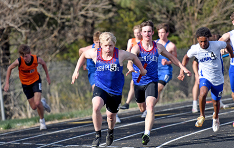 HPC’s Haden Helgoth hands off to fellow senior Gage Friesen for the anchor leg of the 400 relay at last week’s High Plains Invite. The Storm ended up second to Aquinas in a photo finish. 