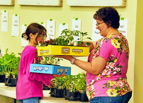 Hampton Booster Club plant sale co-chair Melissa Weedin and her daughter, 5th grader Makenna fill an order for plants on Saturday