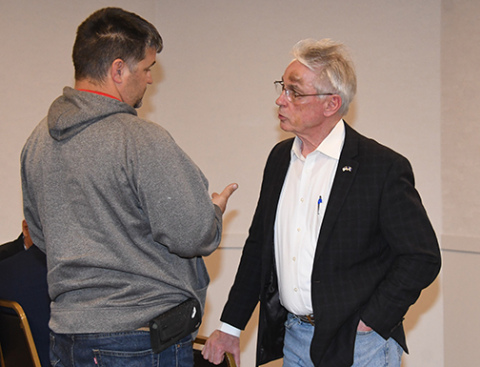Dist. 34 Sen. Loren Lippincott (right) visits with local resident Justin Elge at the town hall forum he held in Aurora on Friday 