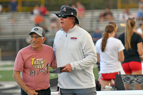 Aurora coach Gordon Wilson receives the Vince Zavala coach of the year award from the man himself during intermisison of April 28's CNTC meet in Grand Island. 