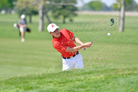 Keelan Phillips digs his way out of the sand on the opening hole at Jackrabbit Run in Grand Island, eventually carding an 84 as part of Aurora’s efforts in Friday’s Central Conference meet.