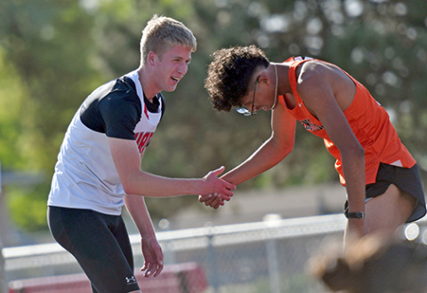Aurora’s Charlie Evans shows great sportsmanship with Lexington’s Herson Rodriguez after the Husky won the 800 meter run at last week’s B-5 district meet.