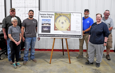 From left: Clinton Griess, Damaris Olsen, Dane Schafer, Todd Roehrs, Danielle Bamesberger and Gene Winters, members of the Hampton Veterans Memorial Committee, stand beside the memorial project display board.
