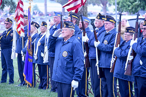 Ron Elge stands and salutes the presentation of colors during the Memorial Day service at the Aurora Cemetery on Monday. 