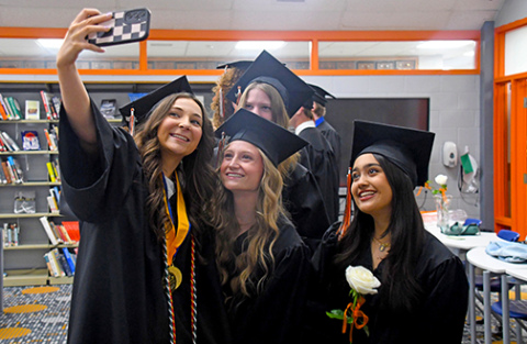 Prior to the graduation ceremony, graduating senior Sophie Faltys (left) takes a selfie with her classmates. Featured in the selfie includes, from left: Jordan Margritz, Giovanna Nogara. In back: Kaitlyn Kothe.