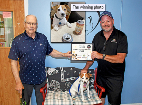Jensen and Chip are pictured at the Aurora animal shelter presenting the prize package to shelter volunteer Roger Holling. The inset photo is the original picture Jensen entered in the contest, entitled "Havin' a beer with Dad."