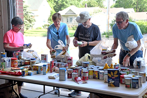 Throughout Tuesday morning, Hamilton County Food Pantry volunteers organized the food collected during Can Care-a-Van before restocking the shelves. From left are volunteers Roberta Cool, Diana Shaffer, Craig Shaffer and Bruce Ramsour.