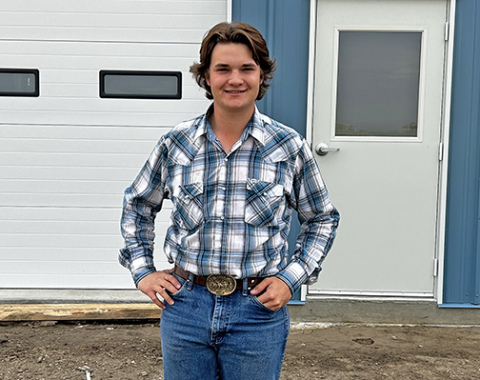 Cooper Kremer stands in front of the new home of UAM Systems, located at the Aurora airport.