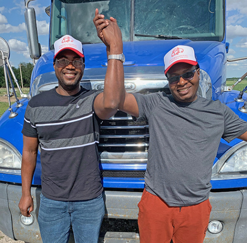 Wallace Mucherengi and Gilbert Chisvo celebrate earning their CDLs through IWS in 2022. Both went on to drive for a Salt Lake City company. 