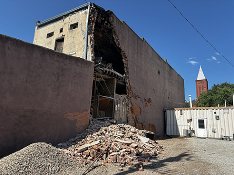 Bricks falling from the north wall of the former Gambles building prompted city officials to close the back alley after the damage was discovered early Thursday morning.