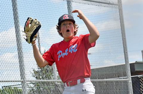Landen Hansen reacts to a safe call at the plate during a home game earlier this season for the Aurora Cooperative Juniors squad. 