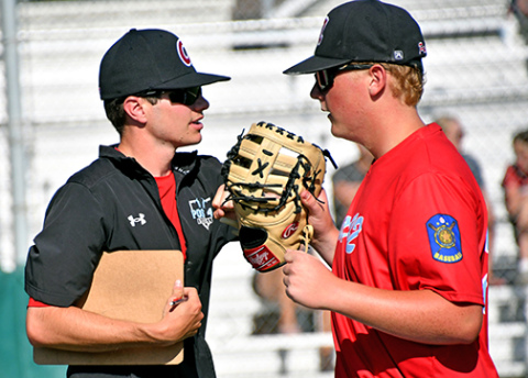 Aurora’s Tate Bendorf, pictured here with Juniors coach Jarrett Havens, tossed a complete game in a 12-4 win over Grand Island. 