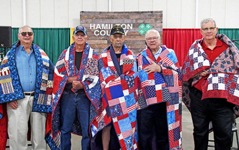 Five veterans were honored with Quilts of Valor in a ceremony hosted by the Hamilton County Thimble Quilt Guild at the Hamilton County Fairgrounds Sunday afternoon. Veterans who received their quilts includes from left: Marvin Weir, Larry Tournor, Dale Saddler, Jerald Reichert and Mike Powell.
