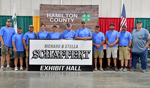 Hamilton County Ag Society member Richard Schaffert (center) was recognized for his service within the Ag Society and Hamilton County for more than 50 years on Thursday night at the opening ceremonies of the county fair. The fairgrounds Commercial Building was renamed the Richard & Stella Schaffert Exhibit Hall in their honor.