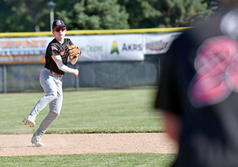Aurora’s Mason Wiens fields a grounder at short and makes the throw to first during the Aurora Cooperative Juniors’ 10-1 win over Kearney July 1. 