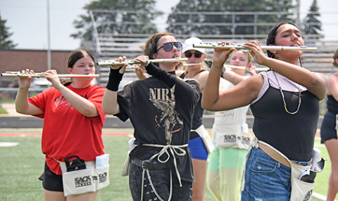 Aurora High School Marching Band flute players pictured above are, from left, Katelyn Dieckmann, Madelyn Freeman and Jessica Rodriguez.