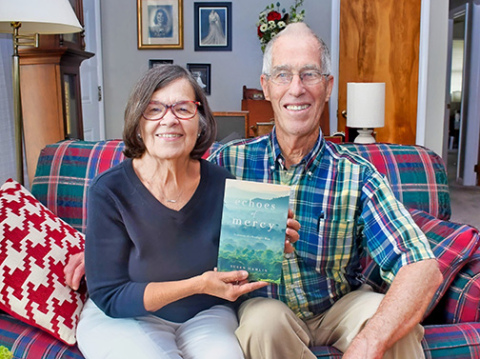 Susan Hamlin displays a copy of her first book, ‘Echoes of Mercy’ which she wrote about the couple’s many years of struggle in raising their adopted son, Nate. Her husband, Newton, a retired Bible translator, served as editor on the project. 