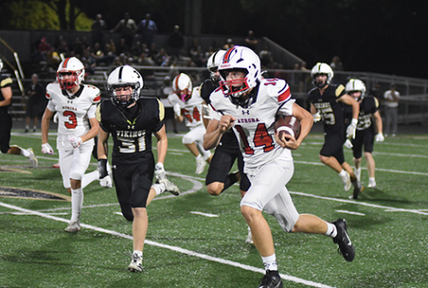 Aurora sophomore Sam Jones (14) made a pivotal play in the third quarter against Northwest, returning a kickoff to the Viking 22 after the Huskies had fallen behind 21-13. “Who would have thought he would be the kick returner that made such a big play,” coach Kyle Peterson said of Jones’ return. “I don’t think he’s probably ever returned a kick in his life, but what a spark for us.”