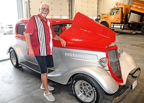 Randy Sabata proudly stands by “Miss Vicky,” a 1933 Ford Vicky which was sort of a retirement gift to himself. Sabata was honored for his 45-year career with the Nebraska Department of Roads/Transportation by more than 100 family, friends and colleagues during a reception Sept. 24.