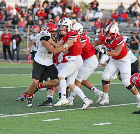 Aurora QB Wyatt Pollet invites contact during the Huskies' 27-20 loss to McCook Friday. 