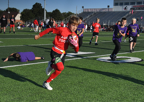  Emory Vap, a member of the Aurora 2nd grade flag football team, is off to the races with a scoring run in Saturday morning's season opener.