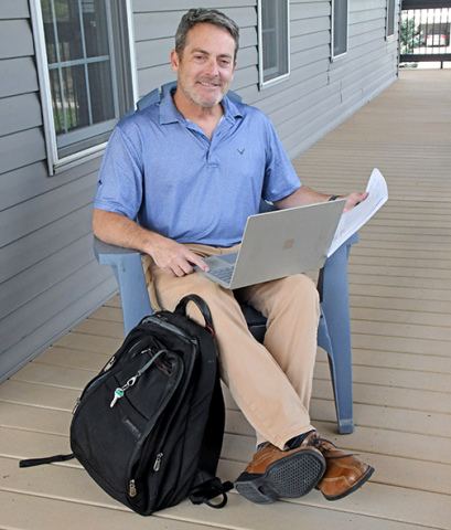 Patent attorney Jeff Morris doesn’t usually work while sitting the deck of his home in Aurora, but he could. Because he works remotely with clients from around the nation, all he needs to do his job is his laptop, an internet connection and the materials in the backpack sitting at his feet. 