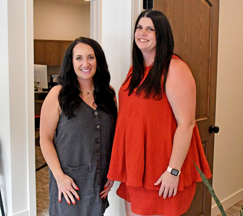 Michaela Robertshaw Garrett, left, and agent Celie Holliday stand in the newly remodeled offices of the M Robertshaw Insurance Agency, located on the east side of the downtown square.