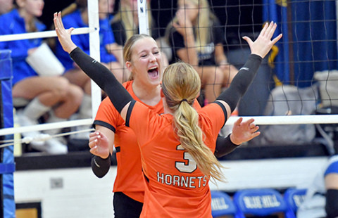 Giltner’s Peyton Schutt (behind) celebrates with Avery Reeson after one of Schutt’s 12 kills in a 3-0 win over Blue Hill Friday night. 