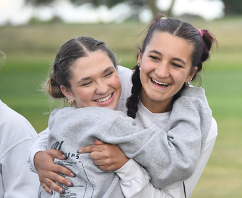 Aurora seniors Ella Eggleston (left) and Lexi Ericksen celebrate after not only a team win in Central City, but an individual gold medal for Eggleston. 