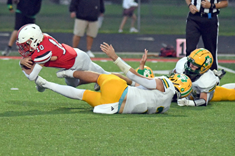 Aurora’s Ian Jensen gets that little bit of extra yardage, part of his 108 yards on 17 carries in the Huskies’ 41-21 win over Columbus Scotus Friday. 