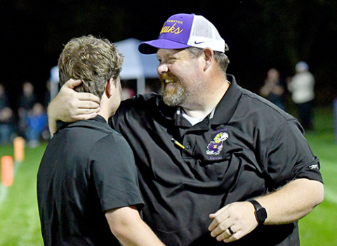 Hampton coach Jereme Jones (right) celebrates with his assistant coach and son, Noah, after the Hawks picked up a ranked win over Pawnee City at home Friday, 27-24. 