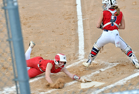 Vivi Fahrnbruch leans out to avoid a potential tag at the plate to score one of Aurora’s two runs in a 12-2 loss to Norris in last week’s B-7 district matchup. 