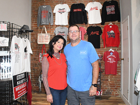 Karla Ericksen and Kris Willcock stand in the display area of their new business, which features the combined creativity of Ruthie Kay Boutique and Krash Grafix.