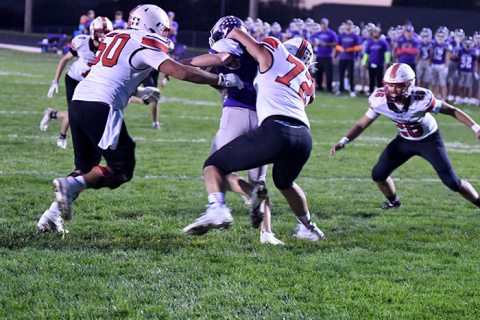 Aurora’s defense almost recorded a safety on this first-quarter play Friday at Milford, as defenders Angelo Holke (50), Tucker Theriot (72) and Gavin Logue (26) bring down a runner right at the goal line.