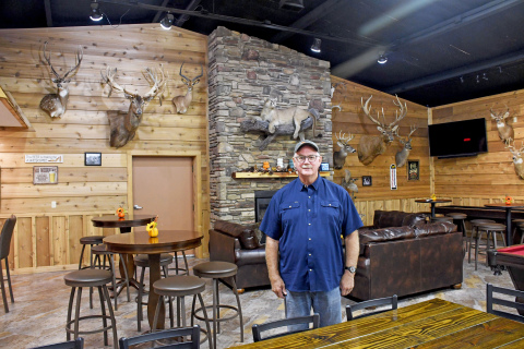 Dean Klute stands in the Bullet in Hampton where he has displayed his collection of trophy animals taken in locations ranging from Wyoming and Montana to New Zealand. He hopes to soon add mounts of the four animals he harvested in South Africa. 