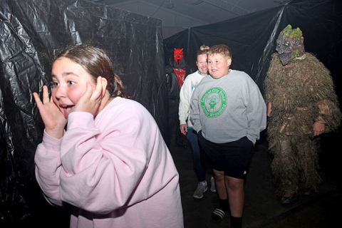 Kaja Brondel (left), followed by her mom Jessica and brother William, runs away from a swamp monster played by Kolby Lautenschlager and a Ghostface (Isacc Graham) at last year’s Haunted Fairgrounds. This year’s event will take place Oct. 24-26 and Oct. 31-Nov. 1.