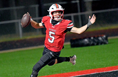 Pictured above, junior quarterback Wyatt Pollet celebrates after scoring a TD to extend the lead to 27-6.